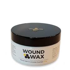 White jar of Wound Wax, a natural barrier salve for horses and dogs, with a black lid featuring a gold bee logo.